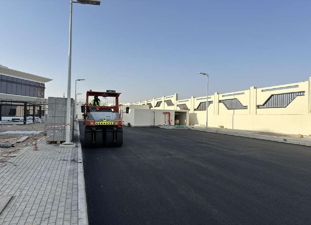 Asphalt paving works on a completed access road